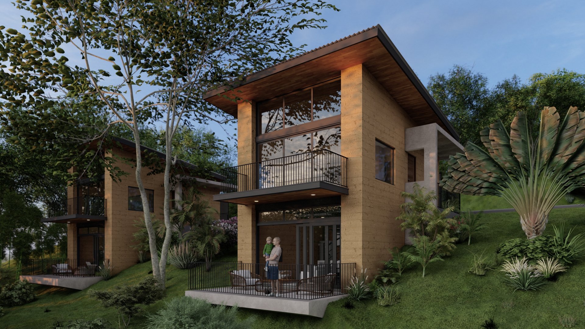 Modern two-story house with large glass windows, surrounded by lush greenery and trees, featuring a balcony and outdoor patio area with seating.