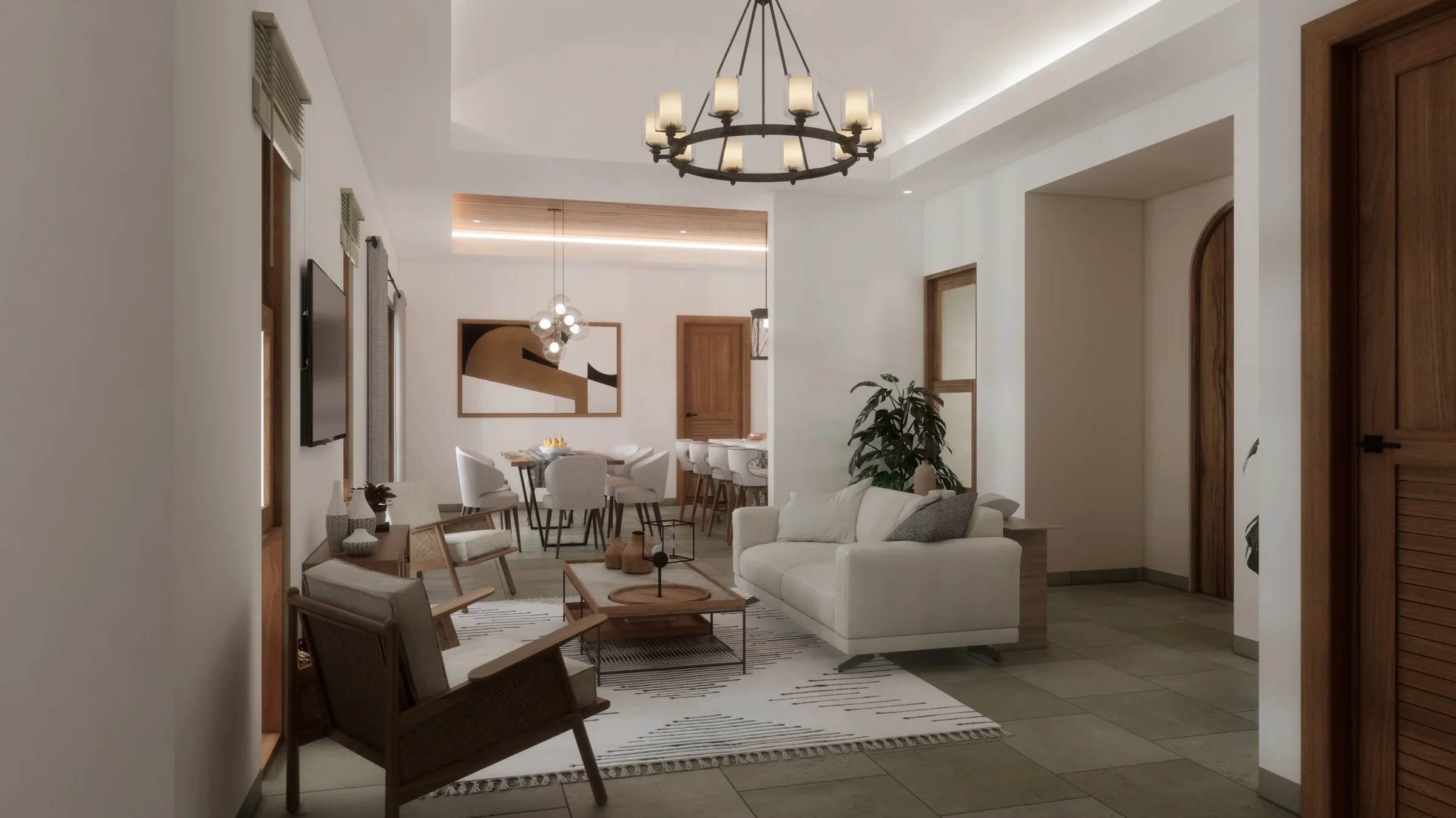 Living room with white sofa, wooden chairs, and a patterned rug, opening to a dining area with a round table and white chairs, illuminated by chandelier and pendant lights, decorated with modern art and plants.