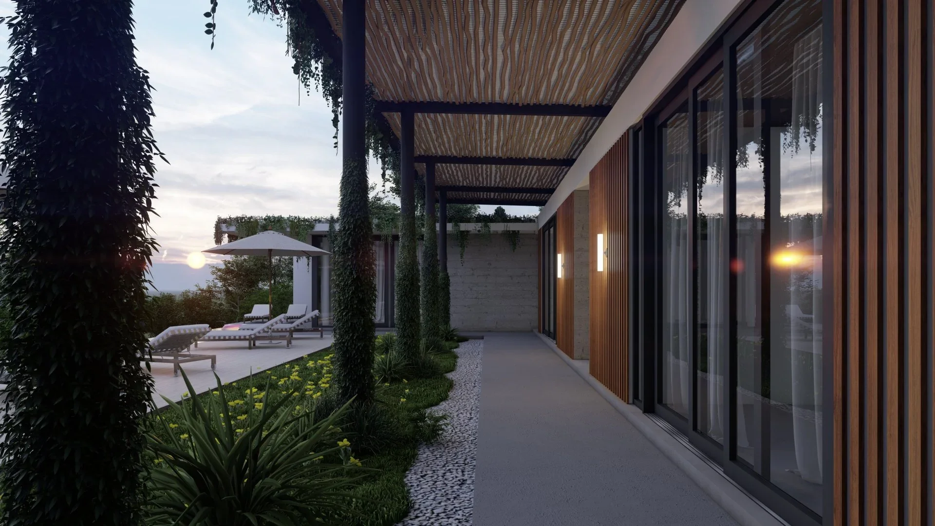 Modern house exterior patio with lounge chairs, umbrella, and garden at sunset.