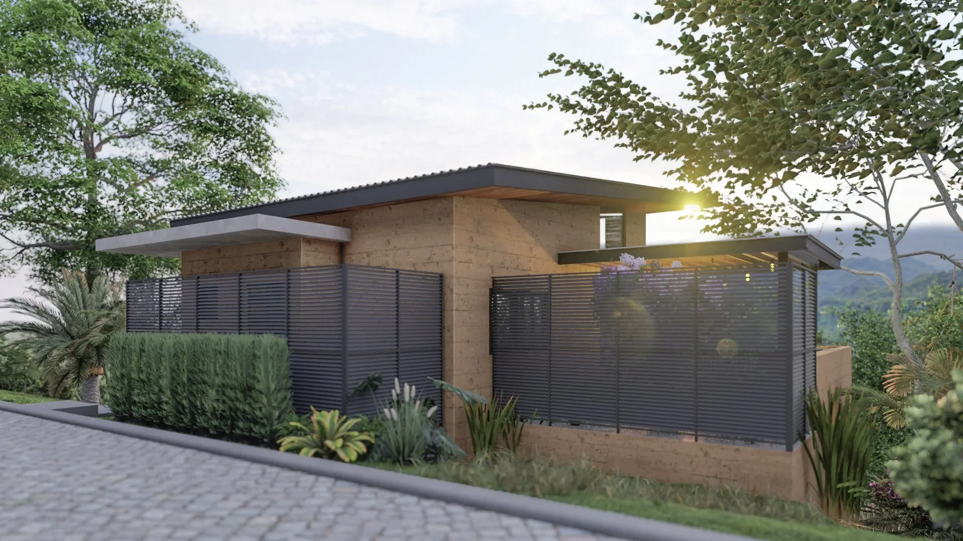 A modern house with beige walls, a flat overhanging roof, and black horizontal fence panels surrounded by lush greenery, with the sun shining through trees in the background.
