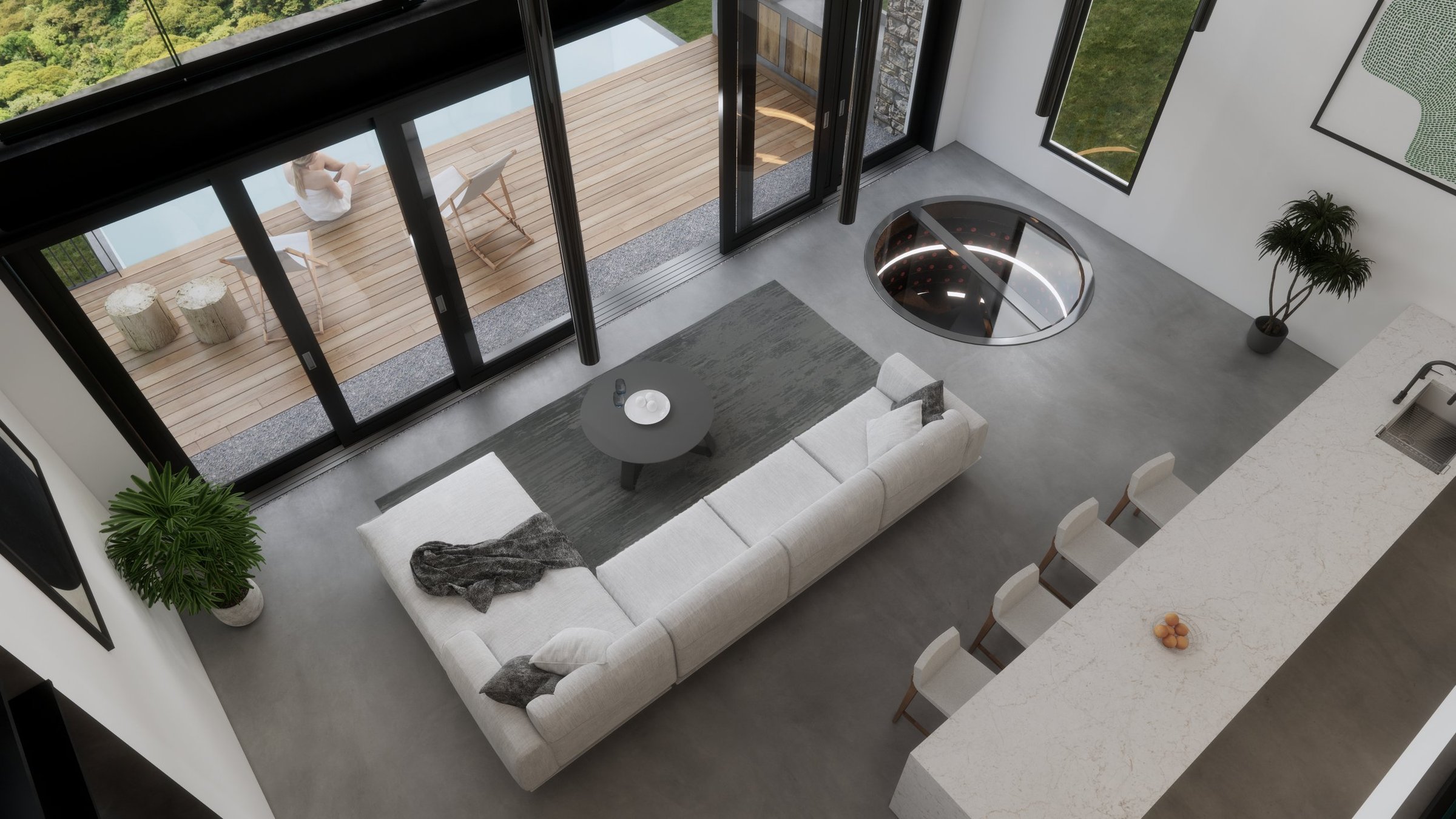Modern living room with a white sectional sofa, gray rug, black coffee table, and large sliding glass doors leading to a balcony with outdoor chairs and a woman sitting outside, overlooking greenery.