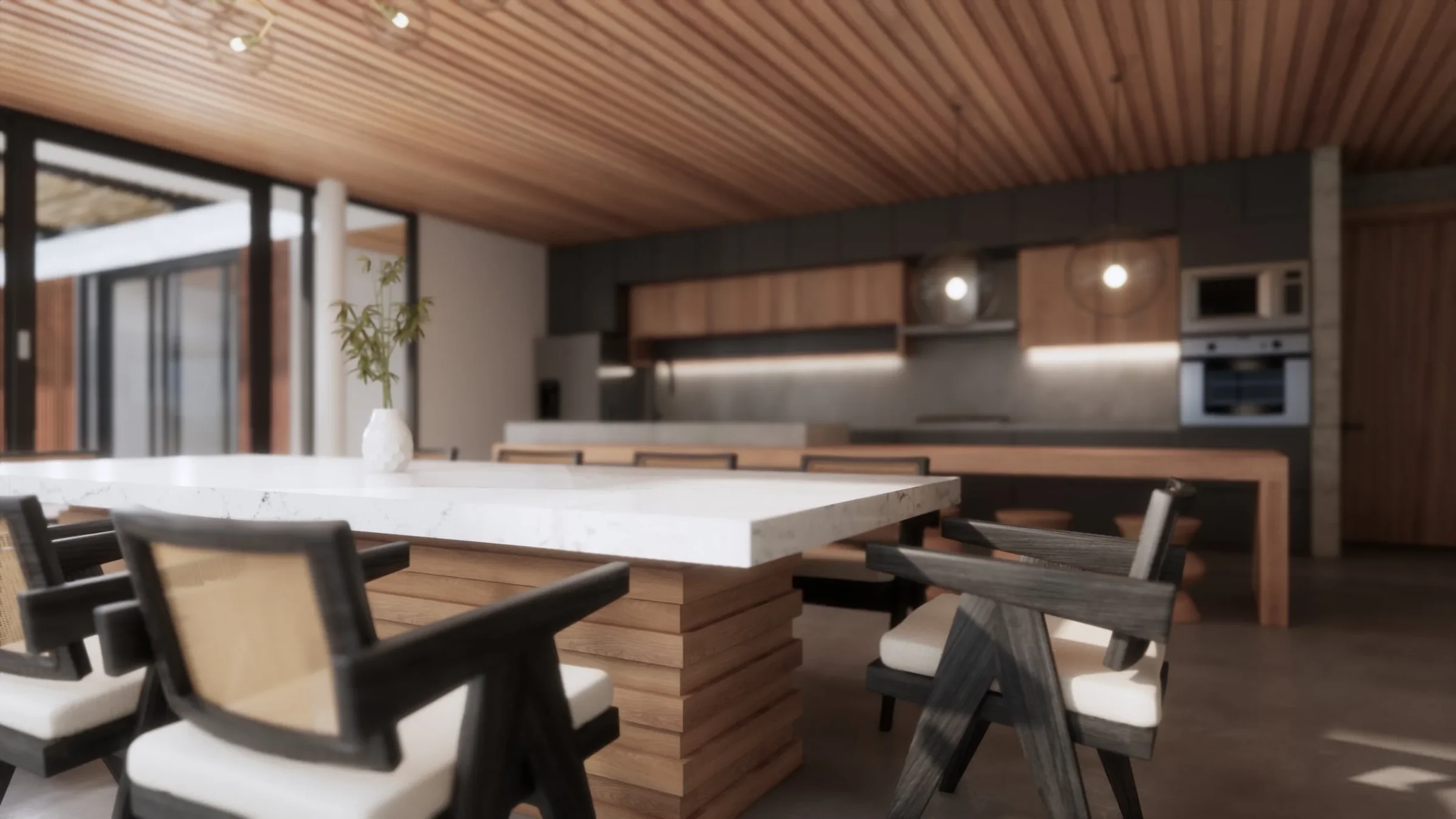 Modern kitchen with a wooden ceiling, large white marble dining table, black and wooden chairs, open kitchen with gray cabinets, built-in oven, and pendant lights.
